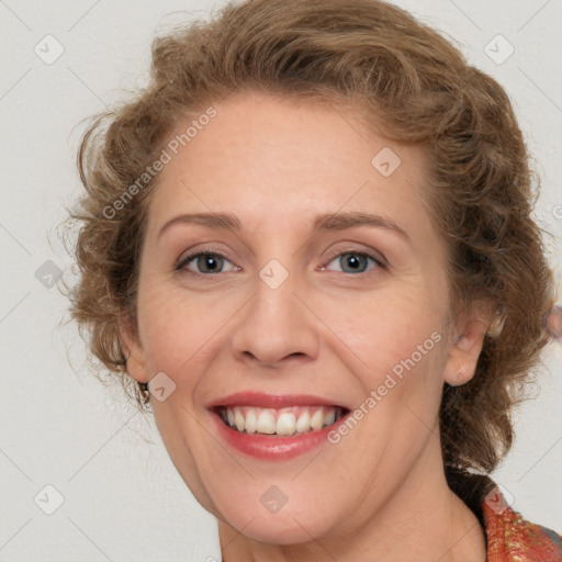 Joyful white adult female with medium  brown hair and blue eyes