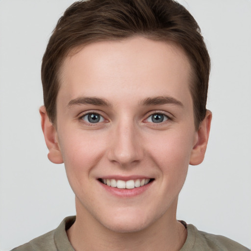 Joyful white young-adult female with short  brown hair and grey eyes