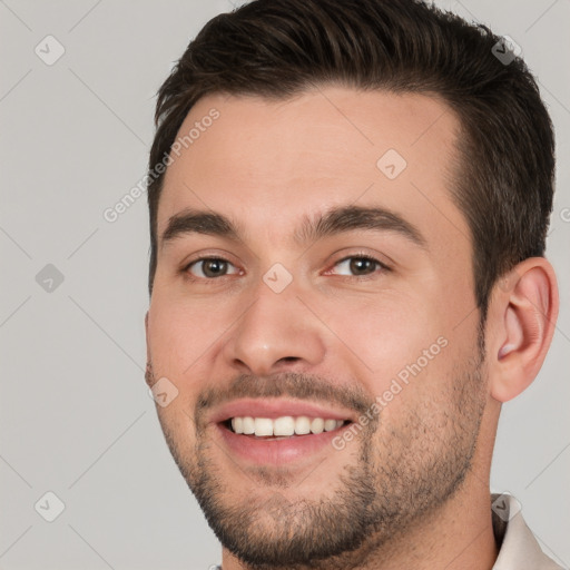 Joyful white young-adult male with short  brown hair and brown eyes