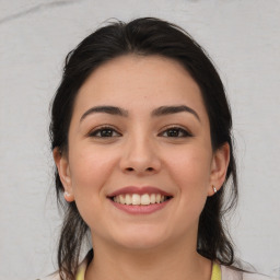 Joyful white young-adult female with medium  brown hair and brown eyes