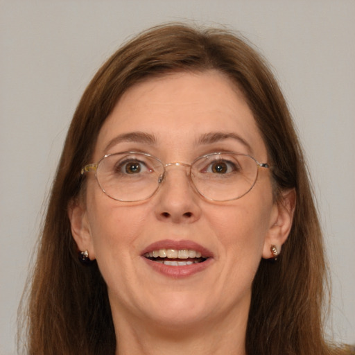 Joyful white adult female with long  brown hair and grey eyes