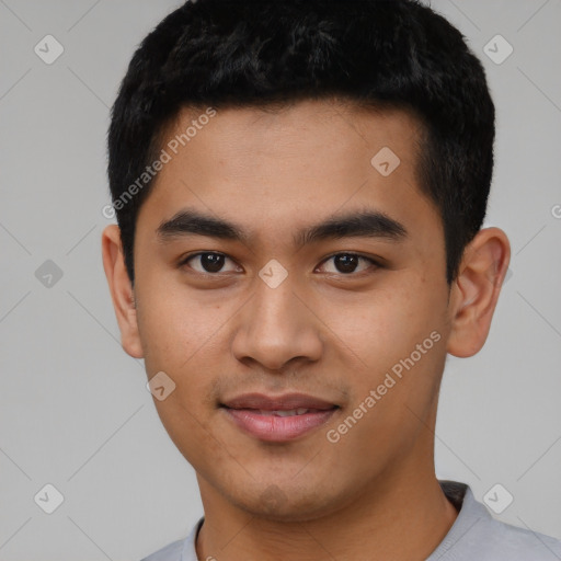 Joyful asian young-adult male with short  black hair and brown eyes