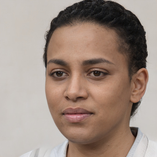 Joyful latino young-adult female with short  black hair and brown eyes