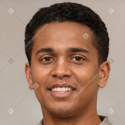 Joyful black young-adult male with short  brown hair and brown eyes