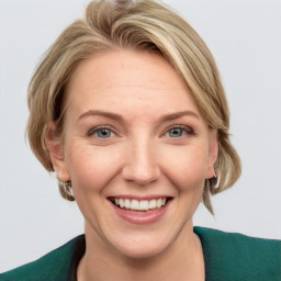 Joyful white adult female with medium  brown hair and blue eyes