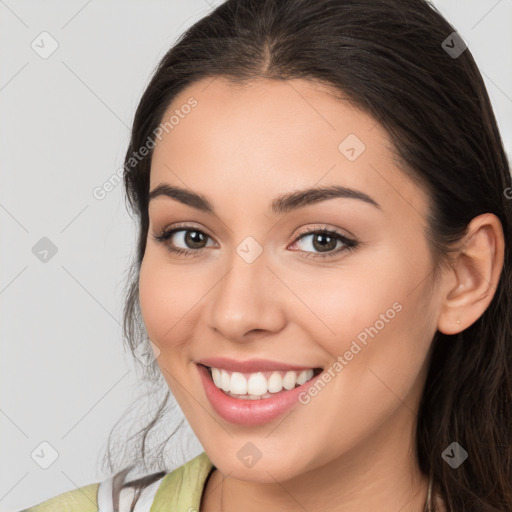 Joyful white young-adult female with long  brown hair and brown eyes