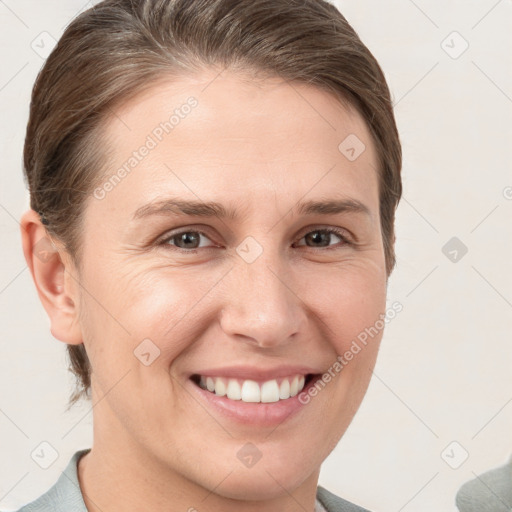 Joyful white young-adult female with short  brown hair and grey eyes