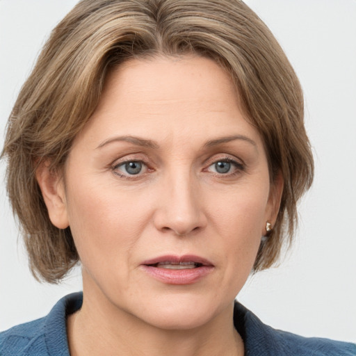 Joyful white adult female with medium  brown hair and grey eyes