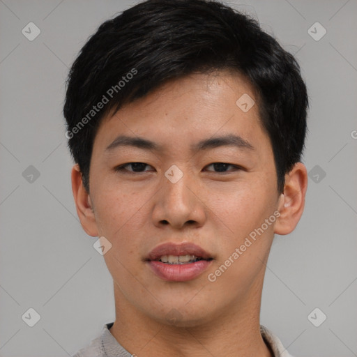 Joyful asian young-adult male with short  black hair and brown eyes