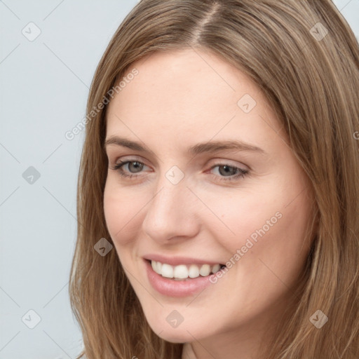 Joyful white young-adult female with long  brown hair and grey eyes