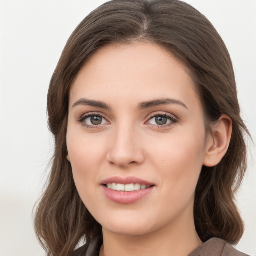 Joyful white young-adult female with medium  brown hair and grey eyes