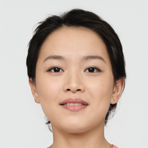 Joyful asian young-adult female with medium  brown hair and brown eyes