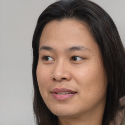 Joyful asian young-adult female with long  brown hair and brown eyes