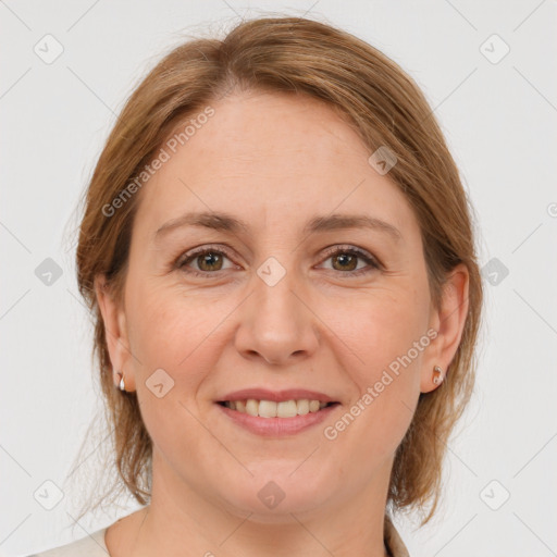 Joyful white adult female with medium  brown hair and grey eyes