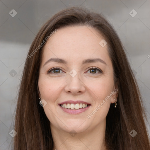 Joyful white adult female with long  brown hair and grey eyes