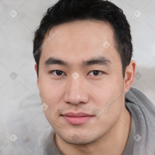 Joyful asian young-adult male with short  black hair and brown eyes