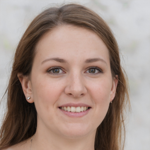 Joyful white young-adult female with long  brown hair and grey eyes