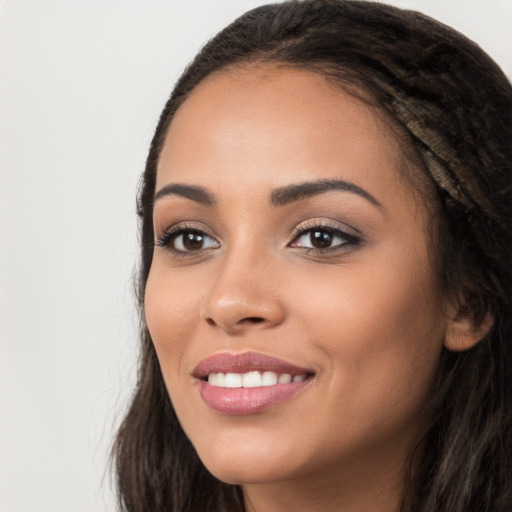 Joyful white young-adult female with long  black hair and brown eyes