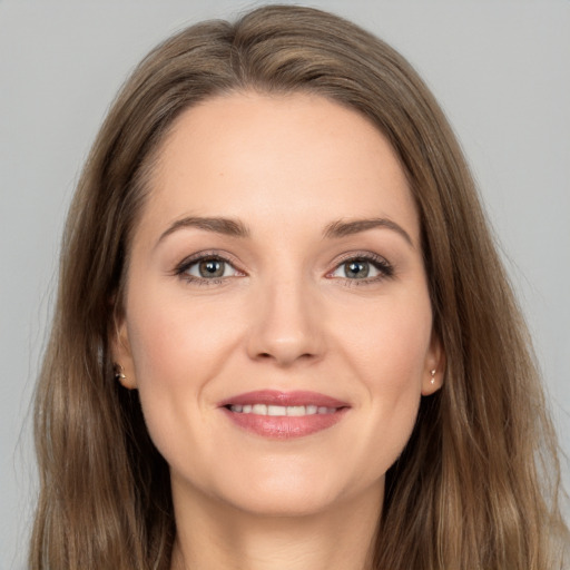 Joyful white young-adult female with long  brown hair and brown eyes