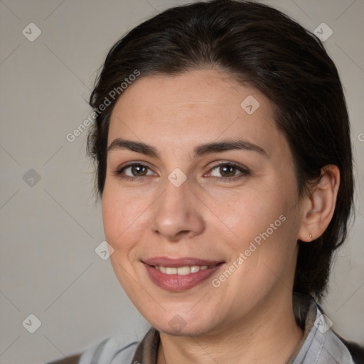 Joyful white adult female with medium  brown hair and brown eyes