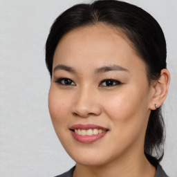 Joyful asian young-adult female with medium  brown hair and brown eyes