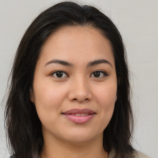 Joyful asian young-adult female with medium  brown hair and brown eyes