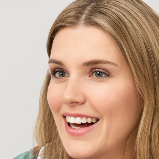 Joyful white young-adult female with long  brown hair and green eyes