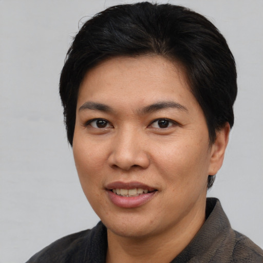 Joyful asian young-adult female with short  brown hair and brown eyes