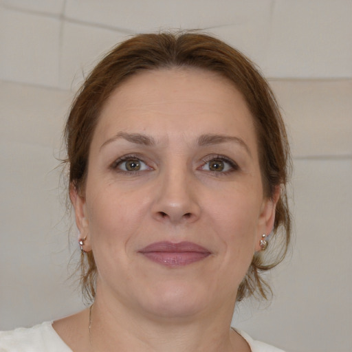 Joyful white adult female with medium  brown hair and brown eyes