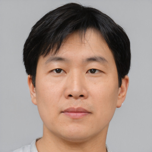Neutral asian young-adult male with short  brown hair and brown eyes