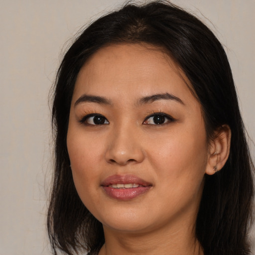 Joyful asian young-adult female with medium  brown hair and brown eyes