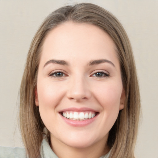 Joyful white young-adult female with medium  brown hair and green eyes