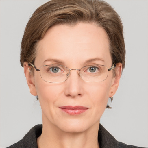 Joyful white adult female with short  brown hair and grey eyes