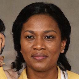 Joyful black adult female with medium  brown hair and brown eyes