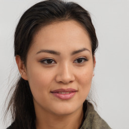 Joyful asian young-adult female with long  brown hair and brown eyes