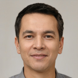 Joyful white adult male with short  black hair and brown eyes