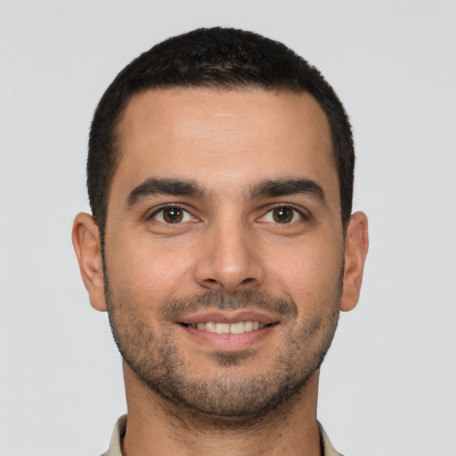 Joyful white young-adult male with short  black hair and brown eyes