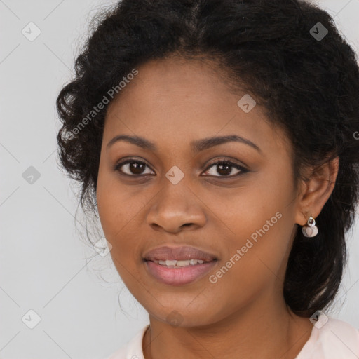 Joyful black young-adult female with long  brown hair and brown eyes