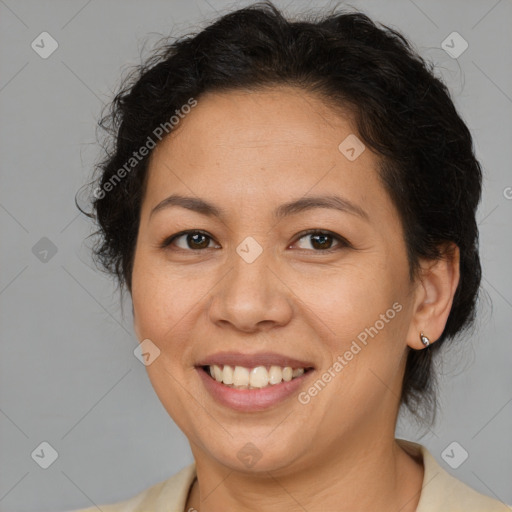 Joyful latino adult female with medium  brown hair and brown eyes