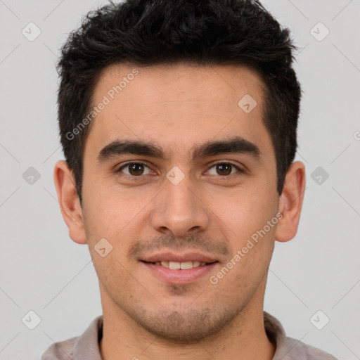 Joyful latino young-adult male with short  brown hair and brown eyes