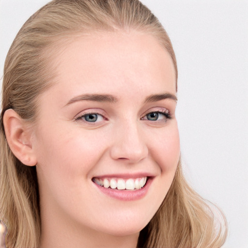 Joyful white young-adult female with long  brown hair and blue eyes