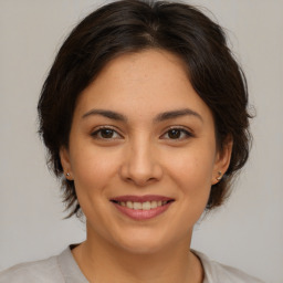 Joyful latino young-adult female with medium  brown hair and brown eyes