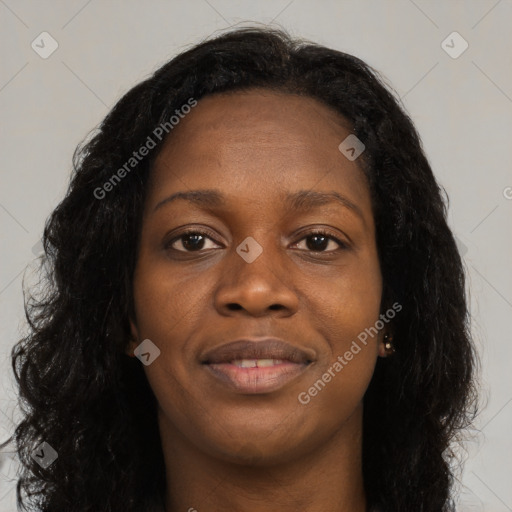 Joyful black young-adult female with long  brown hair and brown eyes