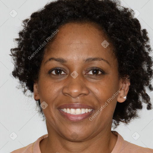 Joyful black adult female with short  brown hair and brown eyes