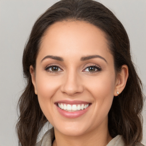 Joyful white young-adult female with long  brown hair and brown eyes