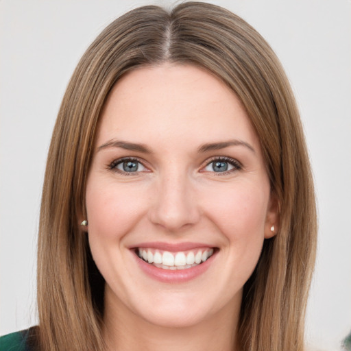 Joyful white young-adult female with long  brown hair and green eyes