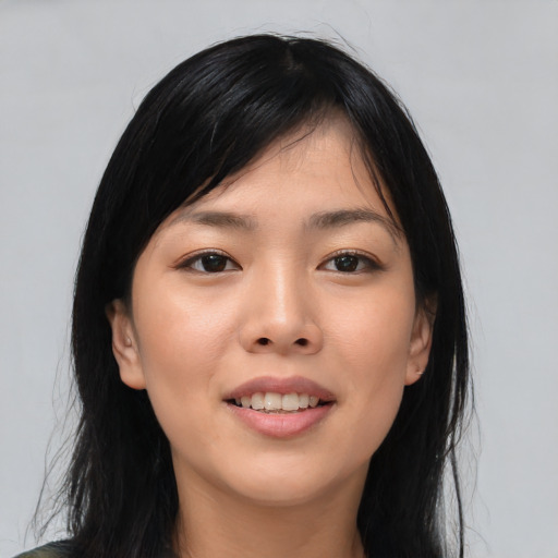 Joyful asian young-adult female with long  black hair and brown eyes