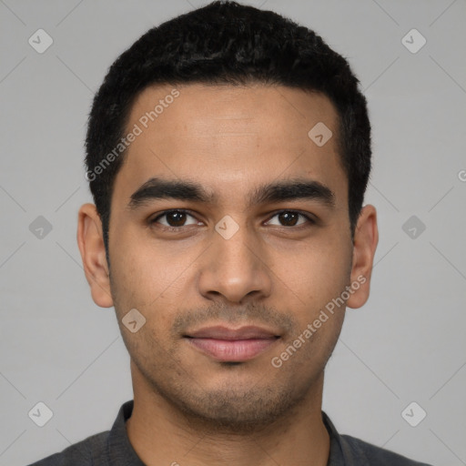 Joyful latino young-adult male with short  black hair and brown eyes