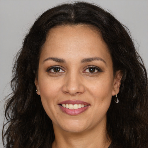 Joyful white adult female with long  brown hair and brown eyes