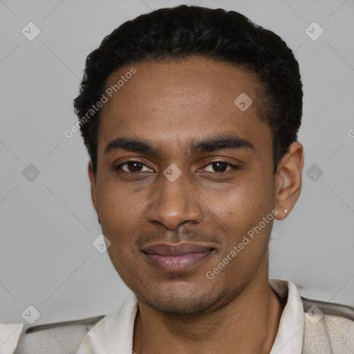 Joyful black young-adult male with short  black hair and brown eyes